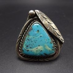 "VINTAGE NAVAJO RING DESCRIPTION: This spectacular ring features a huge triangular cabochon of brilliant blue turquoise. The gemstone is secure in smooth bezel, on a foundation of heavy gauge vintage sterling silver. This ring will be a treasured addition to your collection of fine vintage Native American jewelry. MEASUREMENTS: Ring face measures 1 1/2\" x 1 1/2\" Cabochon measures 23mm x 23mm RING SIZE: 10 3/4 WEIGHT: 17.7 grams SIGNED: no STERLING: unmarked, verified sterling silver yes, stamp Vintage Turquoise Ring With Polished Finish, Collectible Vintage Turquoise Ring With Polished Finish, Vintage Turquoise Ring With Polished Finish For Anniversary, Turquoise Jewelry Rings, Italian Gold Jewelry, Silver Turquoise Ring, Vintage Native American Jewelry, Sterling Silver Rings Turquoise, Turquoise Ring Silver