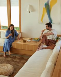 a man and woman sitting on a couch in a living room