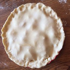 an uncooked pie sitting on top of a wooden table