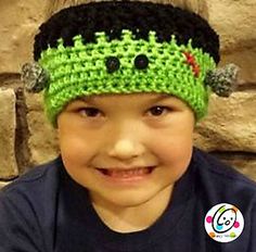 a young boy wearing a green crocheted headband