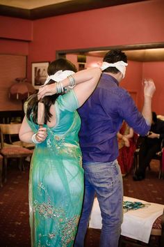 a man and woman dancing together in a room