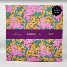 the liberty book is on display in front of a white background with purple and yellow flowers