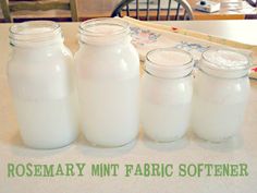 there are many jars on the table with white stuff in them that is labeled rosemary mint fabric softeners