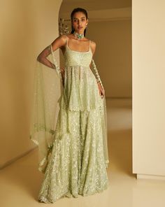 This sharara set features all-over delicate sequin embroidery on a mint green net base. The outfit is paired with a full embroidered peplum top and a matching dupatta.From Seema Gujral's Fiori - the sharara edit collection. DELIVERY TIMEPlease allow 8-12 weeks for your outfit to arrive. FABRIC DETAILSNet Professional cleaning only.