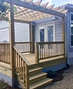 a house with a wooden deck and pergolated roof