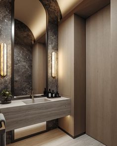 a bathroom with two sinks, mirrors and lights on the wall next to each other