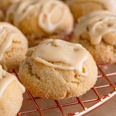 freshly baked cookies with icing sitting on a cooling rack, ready to be eaten