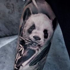 a man with a panda bear tattoo on his arm