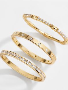 For fans of bands, there's the Maddie 18K Gold Ring Set. Featuring three unique stacking rings, this set can be broken apart on multiple digits or worn all on one. All three of the bands feature petite Cubic Zirconia stones. Crafted with 18K gold plated sterling silver, this is sure to be one of your new favorite pieces of jewelry. Gold Medallion Necklace, Ups Shipping, 18k Gold Earrings, Opal Ring Gold, Jewels Rings, Classy Jewelry, Gold Ring Sets, 18k Gold Ring