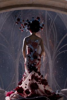 a woman in a dress made out of flowers