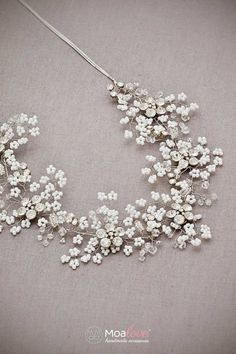 a necklace with white flowers on it