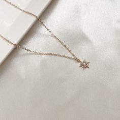 This is a dainty necklace with a sparkly opal star pendant. Perfect for everyday wear. Can be paired with out Scarlett cuff earrings. Opal is the October birthstone and is considered a stone representing hope, innocence and purity. It has strong connotations of happiness, faithfulness, loyalty and confidence. Necklace Metal: 14K Gold filled Necklace Size: 16 in + 2 in extender Pendant Metal : 14K Polished Gold PlatedPendant Size: 11 mm Pendant Stone: Opal and cubic zirconia Model is layering thi Dainty Sparkling Star-shaped Jewelry, Dainty Sparkling Star Jewelry, Elegant Star-shaped 14k Gold Filled Jewelry, Elegant 14k Gold Filled Star Jewelry, Dainty Star-shaped Cubic Zirconia Necklace, Dainty Star-shaped Rose Gold Jewelry, Dainty Cubic Zirconia Star Necklace, Minimalist Star-shaped Cubic Zirconia Jewelry, Dainty Cubic Zirconia Jewelry With Star Charm