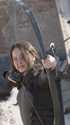 the arrow girl is holding her bow and ready to shoot