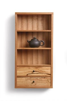 a wooden shelf with two drawers and a teapot on top