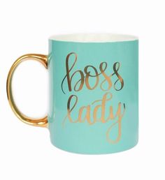 a coffee mug with the words boss lady painted on it and gold rimmed handles