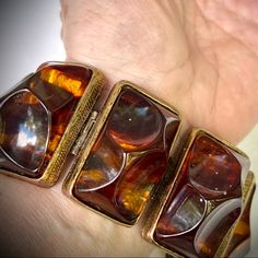 Wow Vintage Chunky Bracelet Features Resin Organically Shaped Semi Transparent Rootbeer Or Tortoise Shell Hued Stones In Rectangular Gold Tone Engraved Style Floral Backed Settings. Rectangles Are Hinged And Linked Together. Bracelet Secures With A Gold Over Clasp. Runway Unique Showstopper! Hard To Fine Retro Bracelet. Measures 7.5" End To End Each Rectangle Measures About 1.5" Long X 7/8" Wide And Sits Almost 1" High Bold Statement Piece! Antique Brown Bracelet Ideal For Gifts, Antique Brown Bracelet Gift, Vintage Amber Bangle Bracelet, Elegant Tortoiseshell Bangle Jewelry, Elegant Adjustable Tortoiseshell Jewelry, Retro Brown Bracelets As Gift, Brown Bangle Jewelry For Formal Occasions, Brown Bangle For Formal Occasions, Brown Rectangular Vintage Bracelet