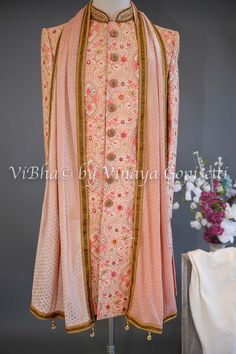 Peach Base With Multicolor Thread And Mirror Work Embroidery Sherwani Set Traditional Chanderi Bandhgala With Mirror Work, Pink Long Sleeve Raw Silk Anarkali Set, Pink Chikankari Embroidery Kurta For Reception, Pink Kurta With Chikankari Embroidery For Reception, Traditional Pink Long Sleeve Bandhgala, Traditional Long Sleeve Pink Bandhgala, Pink Chanderi Long Sleeve Sherwani, Designer Floral Embroidered Traditional Sherwani, Traditional Sherwani With Floral Embroidery