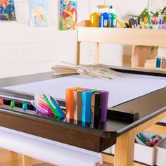 Give your budding artist the perfect comprehensive art space with the Deluxe Art Center by Guidecraft. This all-in-one activity table and storage center features a large, smooth workspace that is the perfect size for creative collaboration between more than one child. Built-in storage shelves hold paints, brushes, crayons, scissors and more. Shelving on the side of the table holds other art supplies and crafting materials. Arts And Crafts Table, Bureau D'art, Kids Art Table, Crafts Table, Craft Supply Storage, Storage Center, Toddler Table, Table And Chair Set, Fabric Storage Bins