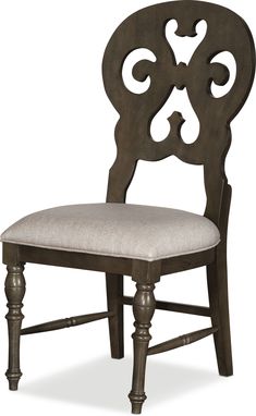 an ornate wooden chair with a white cushion