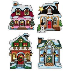 four small houses with snow on the roof and one is decorated in christmas decorations,