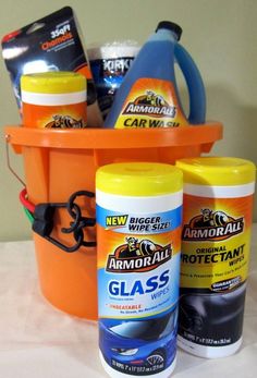 an orange bucket filled with cleaning products on top of a table