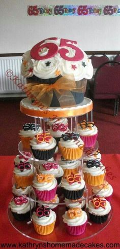 cupcakes are stacked on top of each other in front of a cake stand