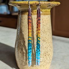 Embrace your inner bohemian goddess with our fan favorite long fringe beaded earrings. This unique rainbow color effect is inspired by a vibrant sunset over the ocean. Beautifully dramatic, comfortably lightweight. Enjoy the playful, free flowing style of beaded fringe earrings, without the weight. Featuring 4 strands of hand woven matte glass beads. These unique matte glass beads have a very luxe look and feel to them. Colors: These beaded earrings feature an ombre fade of semi-transparent purp Long Fringes, Gold Alloys, Rainbow Beads, Grey Glass, Beaded Fringe, Color Effect, Fringe Earrings, Gold Filled Jewelry, Rainbow Colors