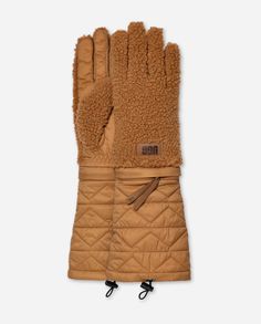 Variety is the spice of life. That's why we designed the AW UGG®fluff Modular Glove with options. Wear them full-length for maximum warmth, or zip off the cuff for a lower profile pair. From the plush fleece UGG®fluff lining ... the cute cuff to the soft fill, these gloves are made with UGG® love. | Plush fleece modular glove. Self - 100% Polyester. Water resistant Quilted Cuff - 100% Recycled Nylon. Microfur Lining - Polyester. Fill - 100% Recycled Polyester. Multi wear. Removable Cuff via zipper. Leather label with Graphic UGG® Font. Imported. | UGG® Women's AW UGG®fluff Modular Glove Fleece Gloves in Chestnut, Size L/XL Fleece Gloves, Leather Label, Cold Weather Accessories, Womens Uggs, Chestnut, Cold Weather, Apparel Accessories, Full Length, Gloves