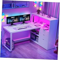 a computer desk with two monitors on top of it in front of a purple wall