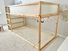 an unfinished bed frame in the middle of a room with white carpet and wallpaper