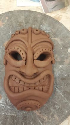 a clay mask sitting on top of a table