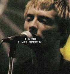 a man singing into a microphone with the words wish i was special written on it