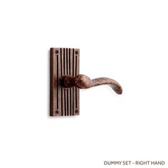 a wooden door handle on a white wall