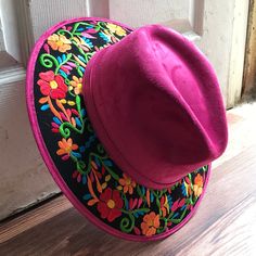 Stand out with this beautiful handcrafted Mexican Suede Hat with beautiful detailed floral embroidered canvas brim. Perfect accessory to add that with that daily outfit. MADE IN MEXICO By: Mexican Artisans For: Women Size: Medium 23' Color: magenta | black | multi Details: Top Suede Embroidered canvas brim Inner elastic band Contact us for more details PLEASE READ BEFORE PURCHASE: The picture is an ACCURATE REPRESENTATION.Colors in the pictures may vary a little by effects of light. Each product Cheap Embroidered Red Hats, Bohemian Pink Felt Hat With Short Brim, Traditional Wide Brim Fitted Hat, Traditional Fitted Wide Brim Hat, Embroidered Brimmed Spring Hats, Spring Embroidered Brimmed Hat, Summer Embroidered Pink Hats, Summer Pink Embroidered Hat, Spring Embroidered Flat Brim Hat