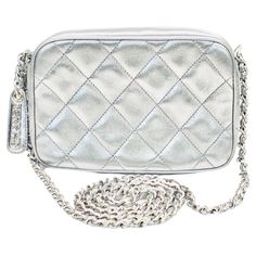 - Vintage Chanel silver metallic quilted lambskin shoulder bag from year 1996 to 1997. - Silver metallic lambskin with silver hardware "CHANEL” zip closure. - Silver hardware chain with silver metallic lambskin shoulder strap. - Silver metallic lambskin interior. - one Interior zip pocket and one slip pocket. - Comes with authentic card, serial sticker, booklet and dust bag. - Size: 16cm x 10cm x 6 cm. Drop: 59 to 60 cm approximately. Vintage Chanel, Fashion Handbags, Silver Hardware, Metallic Silver, Zip Pockets, Chanel, Vintage Items, Dust Bag, Shoulder Strap