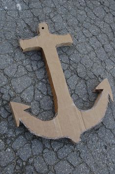 an anchor made out of cardboard sitting on the ground