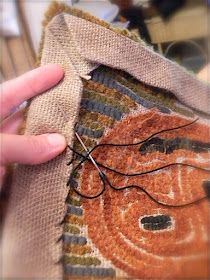 someone is stitching something with scissors on a piece of burlocked fabric