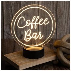 a coffee bar sign on top of a wooden table