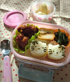 a hello kitty bento box with rice, meat and vegetables