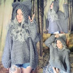 a woman with long hair wearing a gray knitted hoodie and posing for the camera