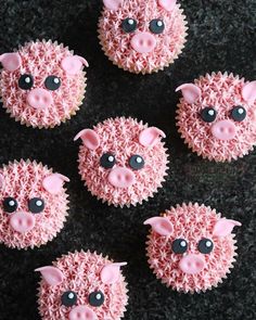 six cupcakes with pink frosting and black decorations on them are shaped like pigs