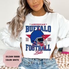 Show your team pride with this amazing Buffalo Bills Football Crewneck! Perfect for cooler days and game nights, this crewneck sweatshirt combines comfort and style, making it a must-have for any Bills fan. Available in a range of sizes, this crewneck offers a great fit for fans of all ages. Its versatile design makes it perfect for layering over your favorite game day outfit or wearing casually. Treat yourself or surprise a fellow Bills fan with this essential addition to their wardrobe. Get re Baseball Season Sweatshirt With Graphic Print For Fans, Game Day Fan Apparel Sweatshirt With Lettering, Football Season Graphic Print Fan Gear Sweatshirt, Team-colored Sweatshirt With Team Logo For Fans, Team-colored Graphic Print Sweatshirt For Football Season, Football Season Fan Gear Sweatshirt With Graphic Print, Collegiate Crew Neck Sublimation Design For Football Season, Team Spirit Sweatshirt With Lettering For Fan Gear, Fan Apparel Sweatshirt With Lettering For Sports Events