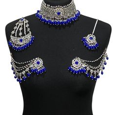 Handcrafted royal blue silver kundan Indian wedding / bridal jewellery set. Set includes- Earrings with multilayer pearl sahara  Choker necklace Jhumar Tikka  Our choker is adjustable with a dori at the back giving you a comfortable fit. It comes with elegant kundan earrings with pearl detail, tikka and jhumar with hooks.  The subtle glimmer of the kundan with elegant pearl detail makes this jewelry set a truly head turning piece, a must have for every jewellery box.  Our ethnic jewellery set ha Silver Kundan Bridal Necklace For Diwali, Metal Bridal Necklace For Wedding, Blue Chandbali Jewelry For Wedding, Silver Kundan Jewelry Sets For Reception, Silver Chandbali Jewelry Sets For Reception, Silver Meenakari Chandbali Bridal Set, Silver Bridal Sets With Stone Work For Ceremonial Use, Silver Bridal Sets For Ceremonial Festive Occasions, Festive Ceremonial Silver Bridal Sets