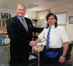 two men are shaking hands in an office