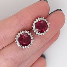 Add a touch of elegance and sophistication to any outfit with these fabulous red ruby studs in 14k white gold. With a sparkling diamond halo and a classic round shape, these studs are the perfect July birthstone accessory. Crafted in solid gold, these statement studs are a timeless addition to any jewelry collection. Vs1 Diamond, Womens Earrings, Synthetic Diamond, White Gold Studs, Sparkling Diamond, July Birthstone, Jewelry Manufacturers, Red Ruby, Diamond Halo