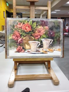 an easel with a painting of flowers on it