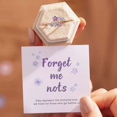 someone is holding up a card that says forget me nots