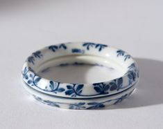 two blue and white dishes sitting on top of each other