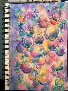 an art journal with watercolors on it