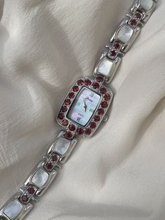 Vintage 1990s Y2K Quartz Solid Sterling 925 Silver Ladies Wristwatch With Mother Of Pearl Dial & Red Gemstone Encrusted Bezel By Gems This is a very beautiful timepiece in remarkable condition  The face is mother of pearl and reflects the light beautifully, it's very clean and the glass lens is scratch free, The face features classy minimalist Roman style silver hour markers on a rectangular face with silver hands. The bezel is encrusted with red gemstones all the way around.  The strap is encru Rectangular Face, Classy Minimalist, Face Features, Red Watch, Vintage Silver Jewelry, Roman Style, Roman Fashion, Red Jewelry, Red Gemstones